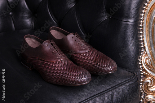Men's shoes on the couch. Elegant shoes. A pair of handsome men's shoes close-up. Beautiful shoes in the interior. © fortton
