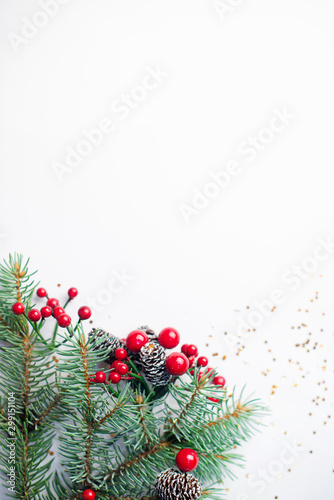Christmas composition flatlay. Spruce branches, red berries on white background with space for text