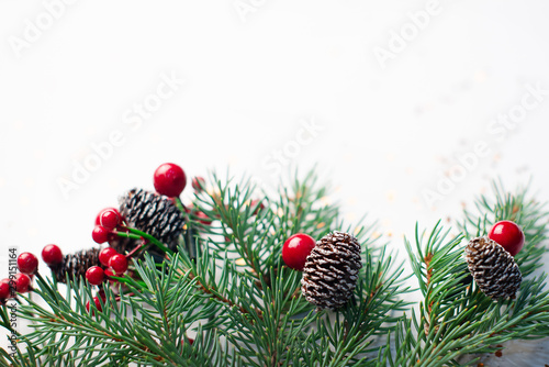 Christmas composition flatlay. Spruce branches, red berries on white background with space for text