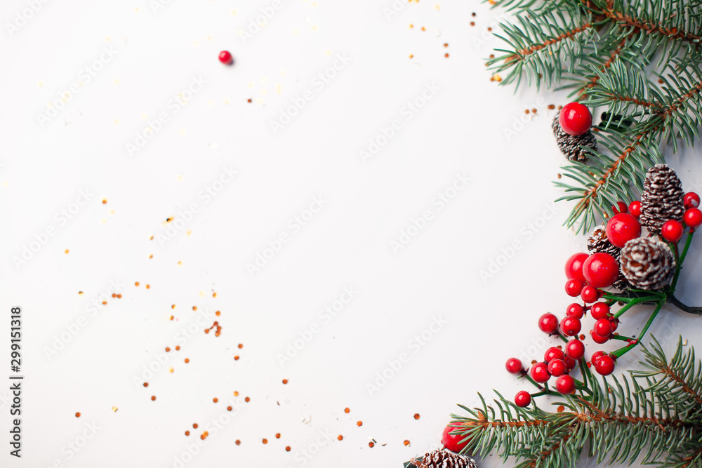 Christmas composition flatlay. Spruce branches, red berries on white background with space for text