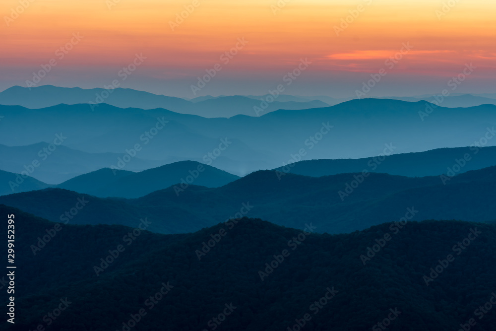 Scenic drive from Cowee Mountain Overlook on Blue Ridge Parkway at sunset time.