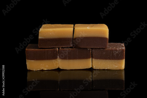 Group of five whole sweet brown caramel chocolate candy isolated on black glass