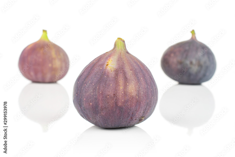 Group of three whole fresh purple fig isolated on white background Group of three whole fresh purple fig isolated on white background