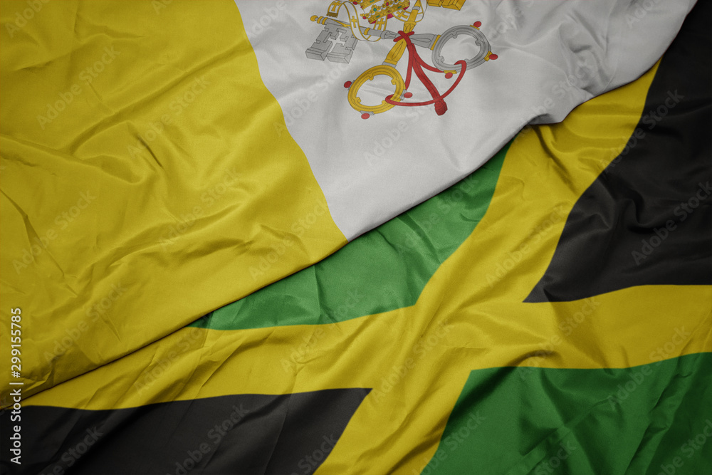 waving colorful flag of jamaica and national flag of vatican city.