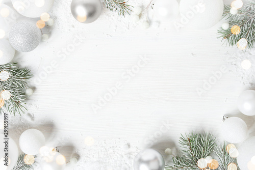 White Christmas background with spruce frosty brunches and Christmas lights photo