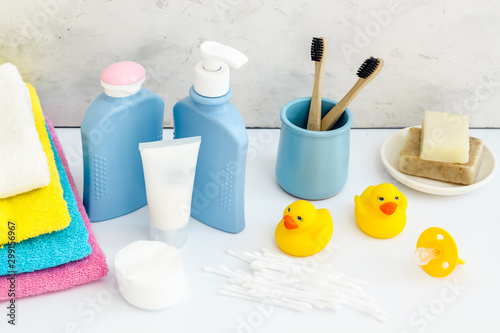 Baby bathroom cosmetics near pacifier and rubber duck on white background