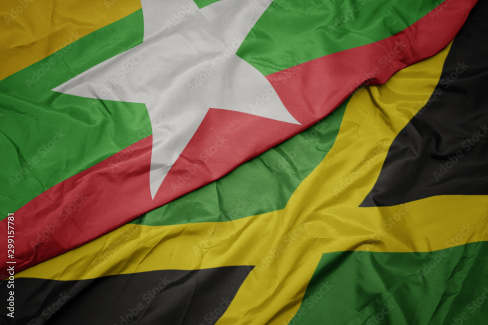 Obraz premium waving colorful flag of jamaica and national flag of myanmar.