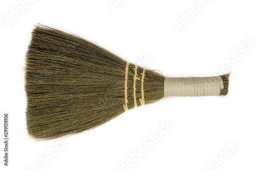 Straw broom on white background