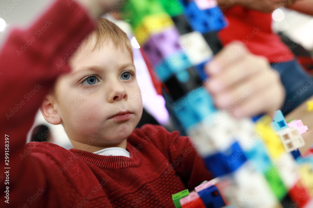 Kid playing plastic constructor Kid playing plastic constructor