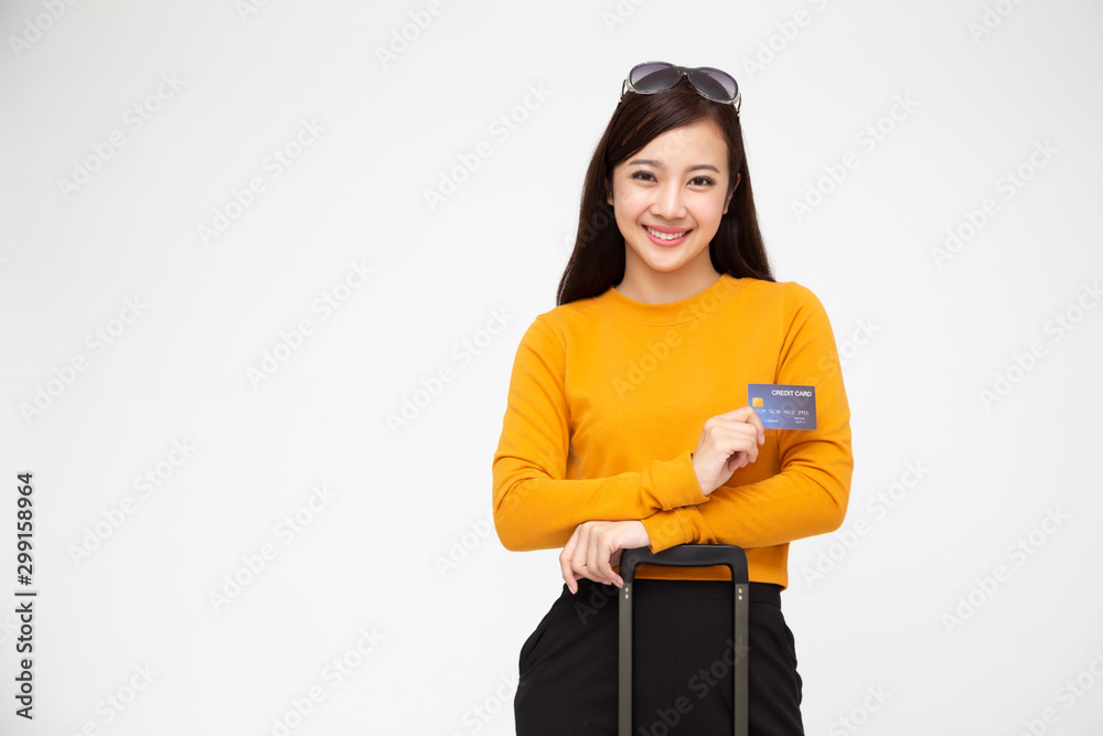 Portrait of smiling woman traveler holding credit card isolated on white background Portrait of smiling woman traveler holding credit card isolated on white background