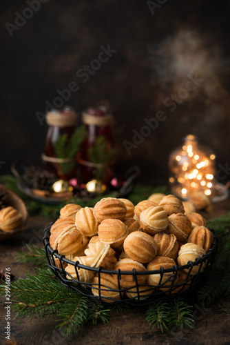 Christmas dessert cookies nuts with boiled condensed milk on a dark background with garlands and Christmas decorations.