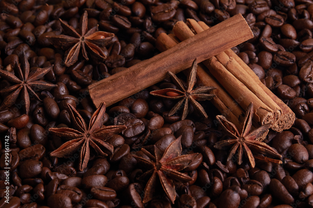 cinnamon and Star Anise on a bed of coffee beans cinnamon and Star Anise on a bed of coffee beans