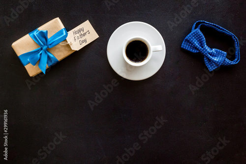 Father's Day concept with bow tie, present box and concept. on black background top view frame copy space photo