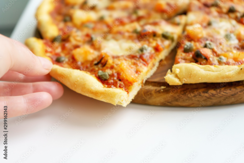 Cut into slices italian pizza with seafood on white background Cut into slices italian pizza with seafood on white background