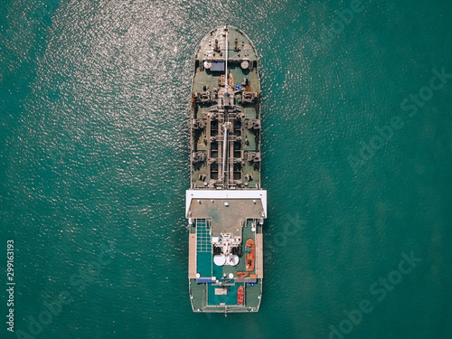 Big oil tanker sailing blue sea to the coastal depot, top view  fuel concept. © Semachkovsky 