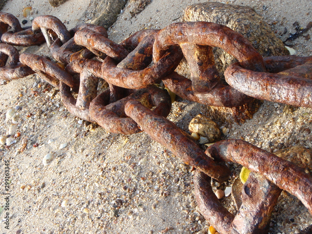Large rusty chains on beach Large rusty chains on beach