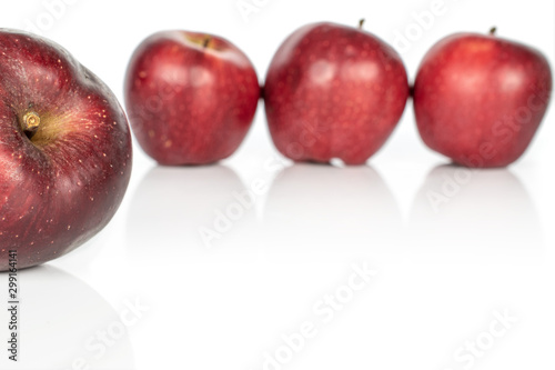 Group of four whole fresh apple red delicious isolated on white background