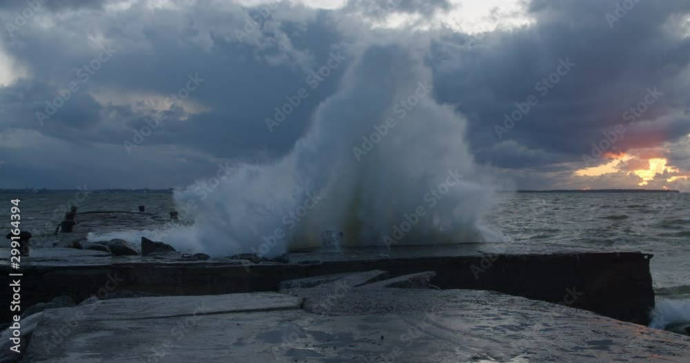 Big storm waves crashing to pier resulting high spray water cascade