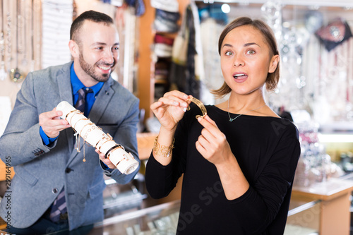 Portrait of woman customer trying bracelet
