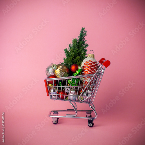 Christmas tree with decorations in a supermarket cart. Christmas shopping and sale concept