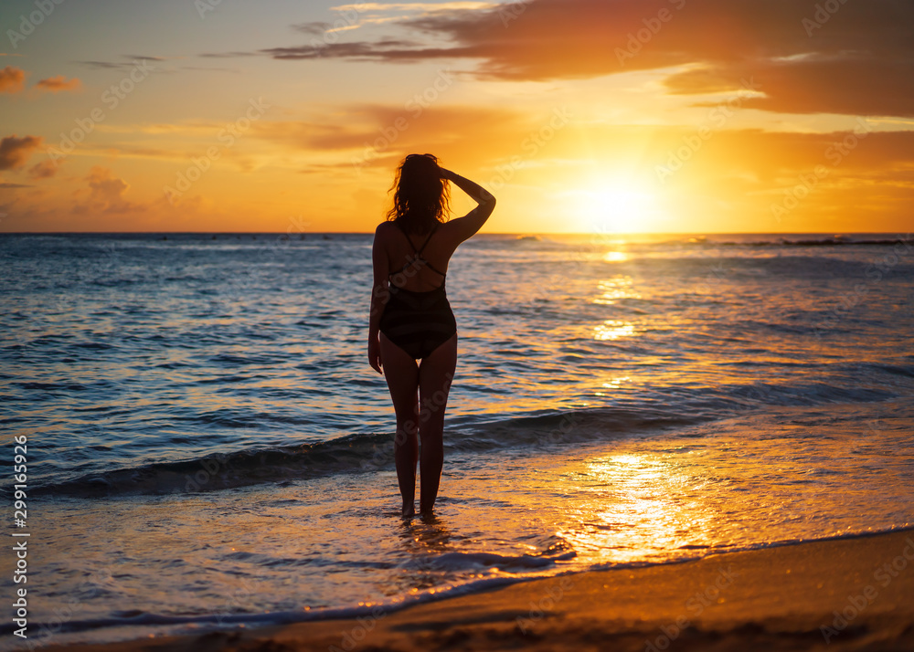 Young Woman Watching Sunset at The Beach