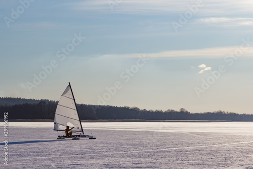 Sailboat on a frozen lake. Ice iceboating competition. Winter sport.