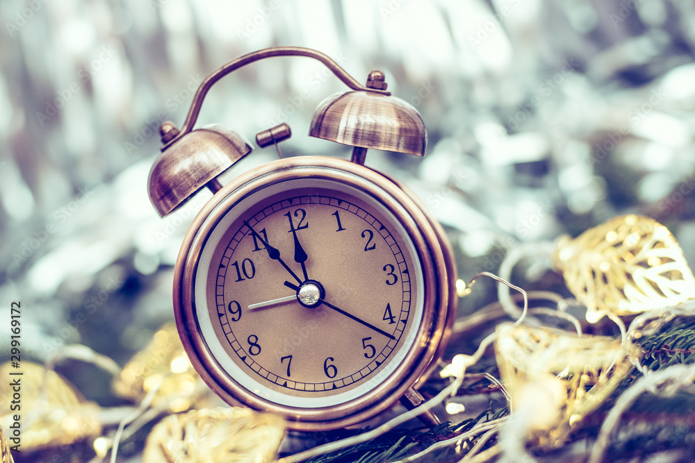 Close up of retro alarm clock on blurred Christmas background with bokeh
