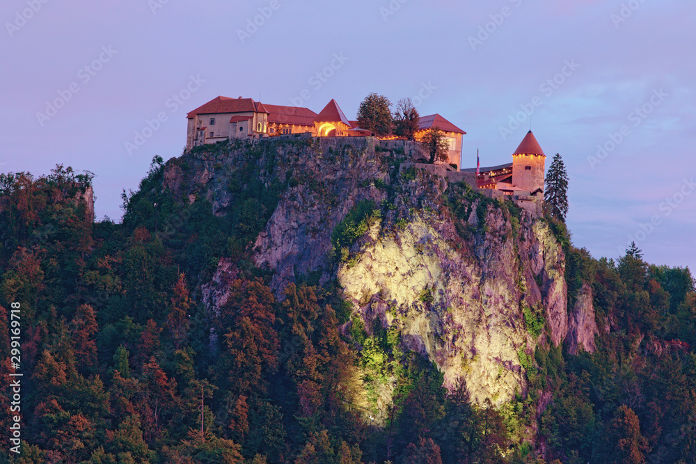 Beautiful landscape photo of Bled Castle on the top of the rock during sunset. Autumn landscape of touristic place and travel destination in Slovenia