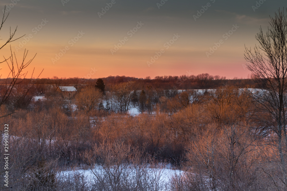 Sunset over snow covered fields