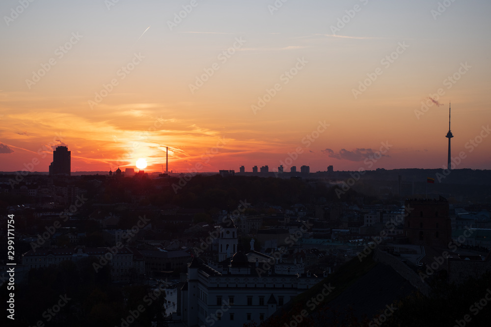 Beautiful orange sunset over the city and Vilnius TV tower 