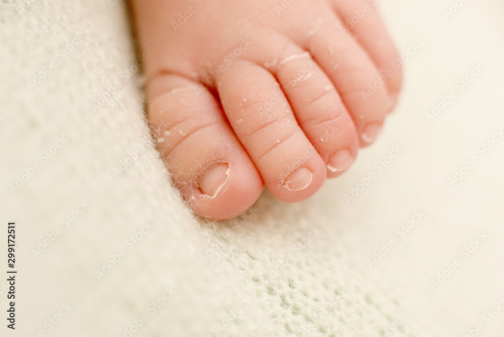 foot of the newborn baby, peeling skin, fingers, maternal care, love and family hugs, tenderness foot of the newborn baby, peeling skin, fingers, maternal care, love and family hugs, tenderness