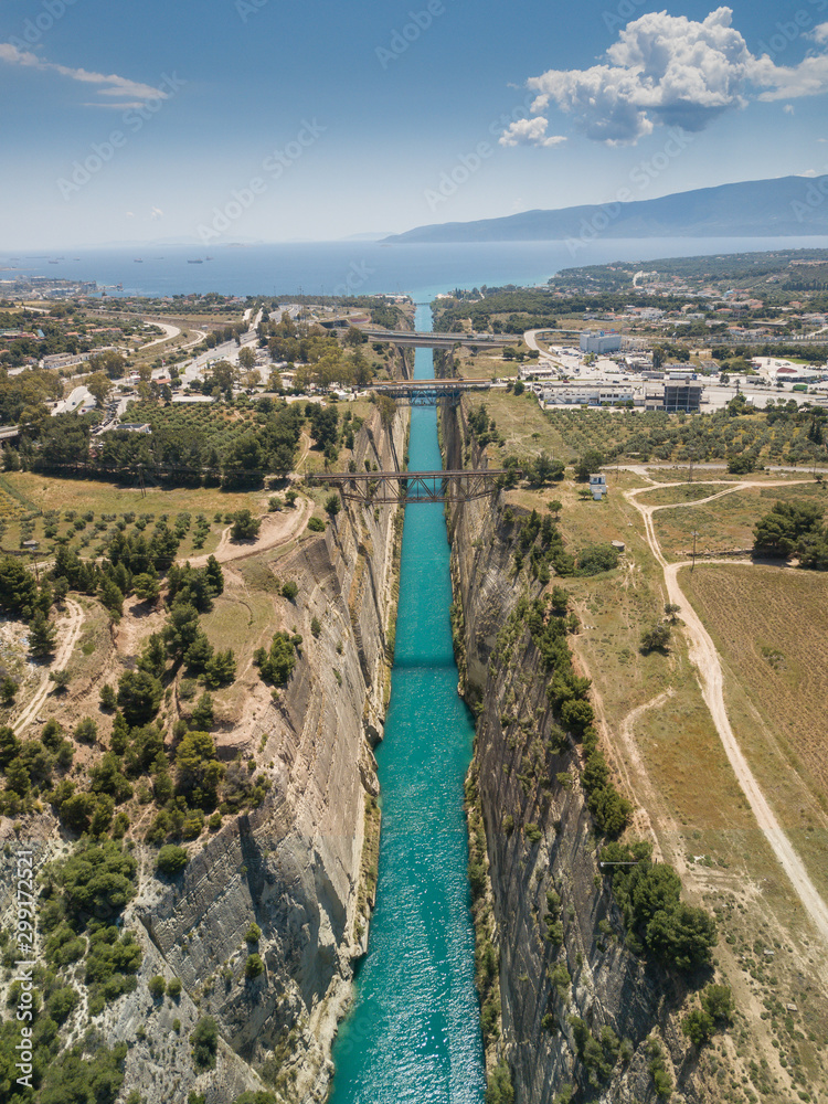 Aerial bird's eye view photo taken by drone of famous Corinth Canal with turquoise water, Peloponnese, Greece. The narrowest channel in the world and engineering marvel.