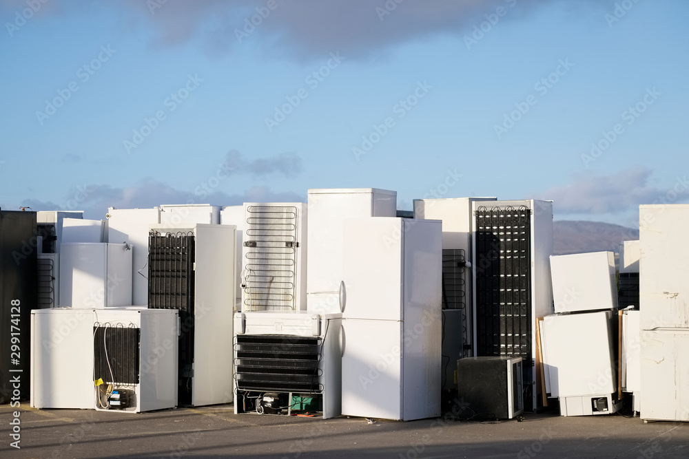 Old fridges freezers refrigerant gas at refuse dump skip recycle