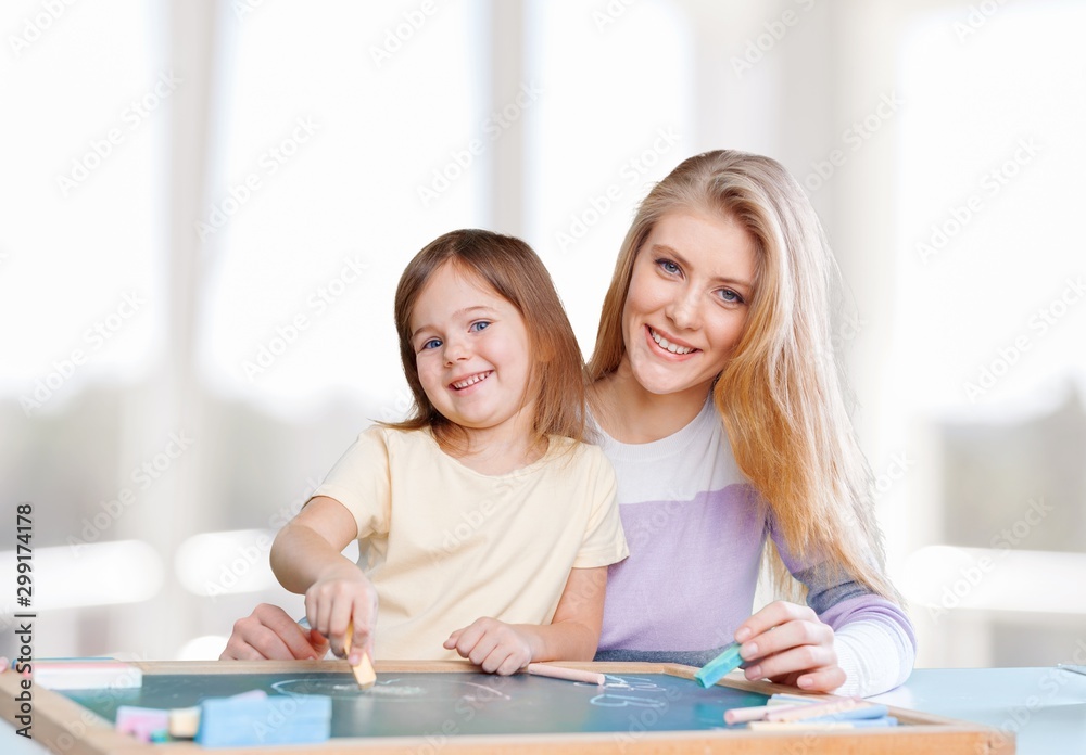 Beautiful mother and cute daughter using laptop Beautiful mother and cute daughter using laptop