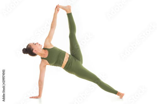 Portrait of gorgeous young woman practicing yoga indoor
