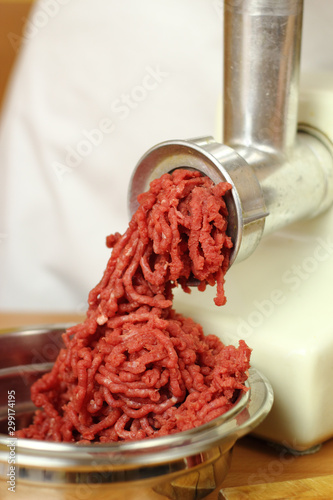 Mincing beef by meat grinder