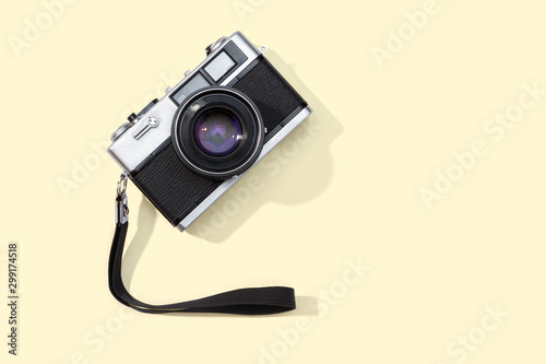Flat lay film camera isolated on yellow background. Copy space