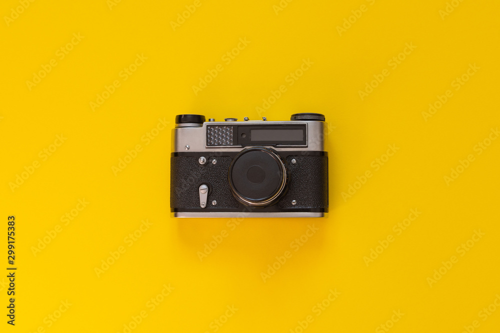 Retro camera closeup isolated on yellow background Retro camera closeup isolated on yellow background