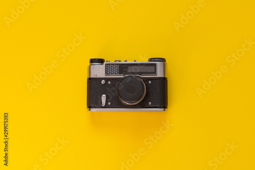 Retro camera closeup isolated on yellow background