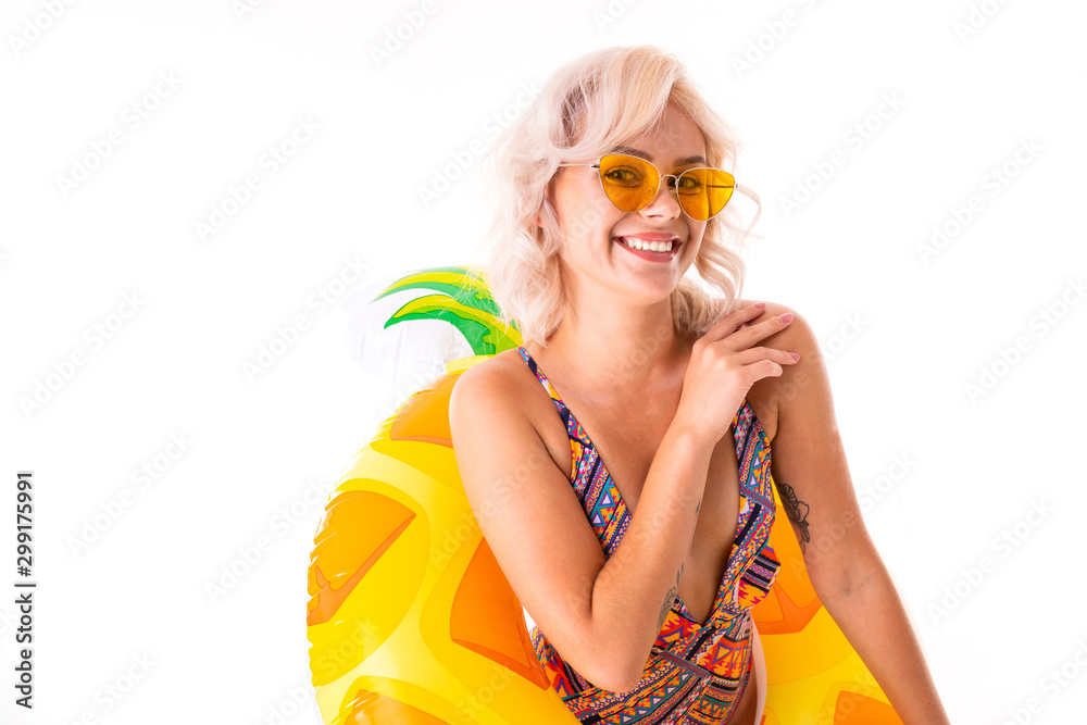Photo of smiling beautiful woman wearing swimsuit standing in swim ring isolated white background Photo of smiling beautiful woman wearing swimsuit standing in swim ring isolated white background