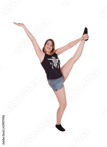 Dancing young woman in shorts in the studio