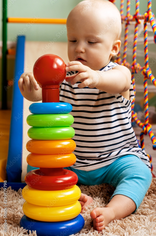 Educational logic toys for children. A child collects a colored pyramid. Montessori games for the development of the child. Early development Educational logic toys for children. A child collects a colored pyramid. Montessori games for the development of the child. Early development