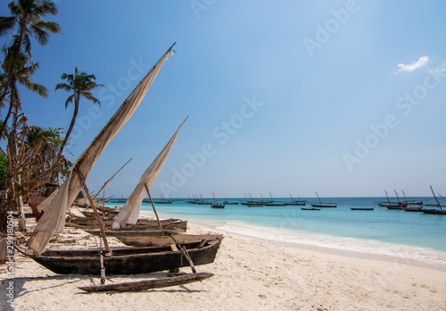 Traditional wooden sailing boats in Africa. Dhow on a beach on the shores of the Indian Ocean in northern Zanzibar.