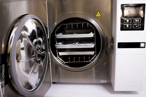 Sterilizing medical instruments in autoclave. Equipment for sterile cleaning of working medical instruments. © Nina