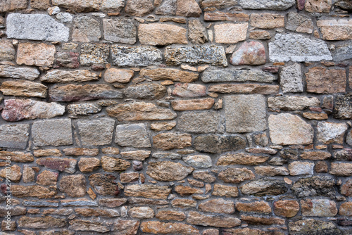 Texture of a stone wall. Old castle stone wall background. Wall made of wild stone. Natural background.