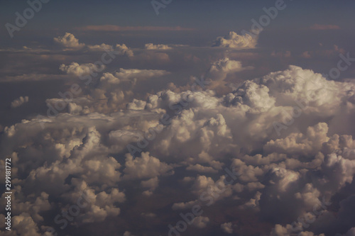 Top view of clouds from an airplane window on a sunny day © liusan 