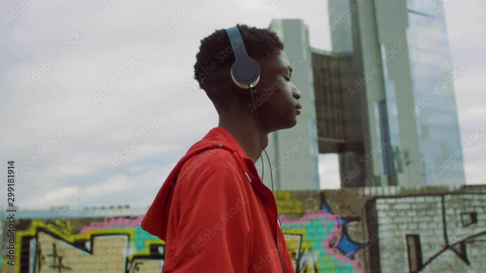 Young man walking with headphones