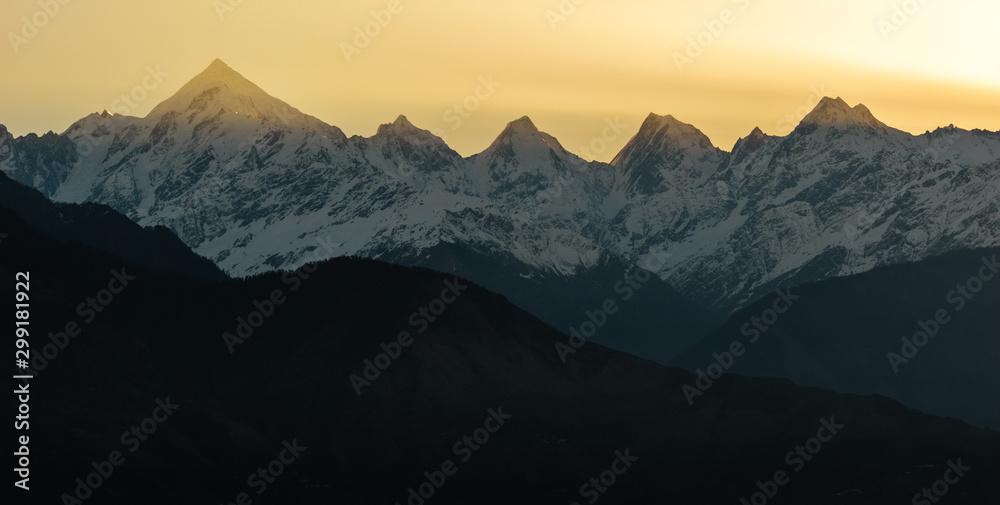 The rays of the early morning sun hit the peaks of the Panchachuli mountains in Munsyari in the Indian Himalayas.