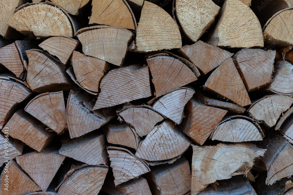 A pile of wood stacked in front of the house for long and cold winters. The wood is to keep the fire place warm and the fire going. A pile of wood stacked in front of the house for long and cold winters. The wood is to keep the fire place warm and the fire going.