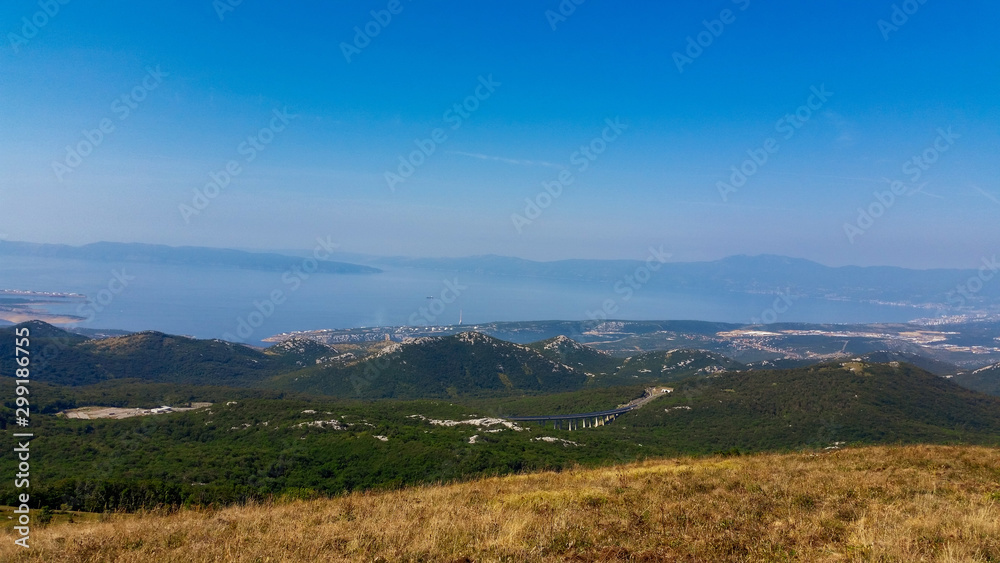 Obraz premium Mountain and hills landscape with the the sea and sky in the background. Tuhobić, Hreljin, Croatia